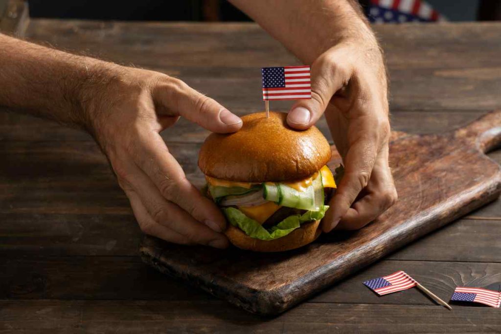 high-angle-hands-holding-tasty-burger