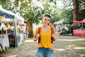 traveler enjoying open air market in all smiles